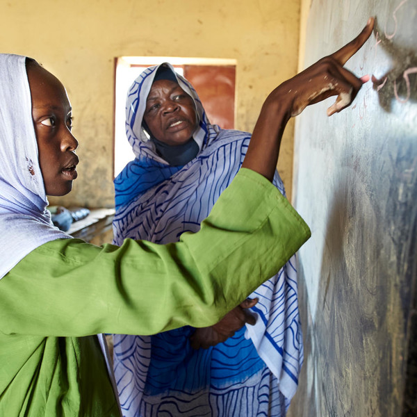 Child and teacher inside a classroom during class
