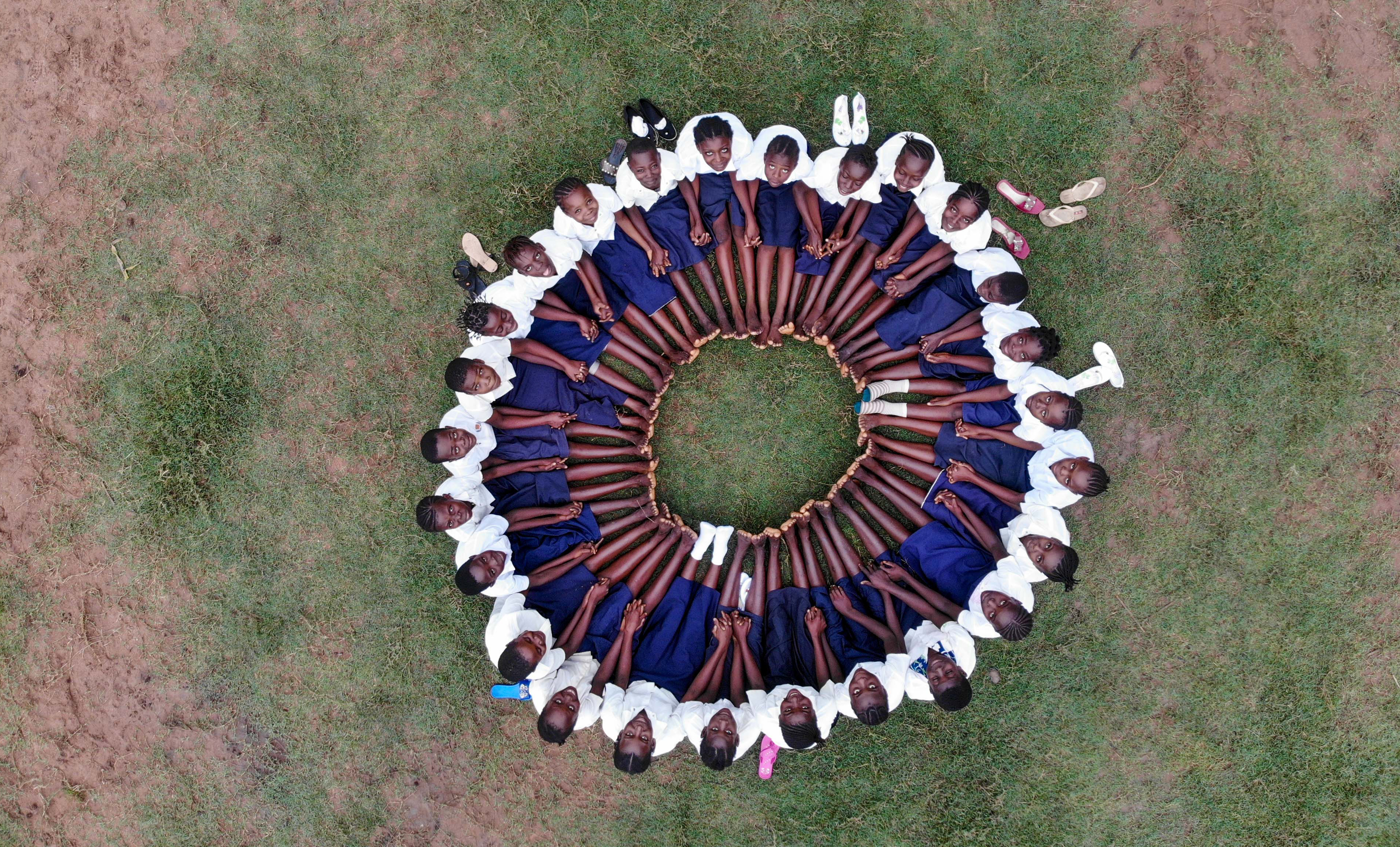 Girls seated in a circle in the DRC.