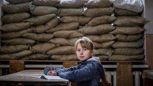 Girl sitting in a classroom in Ukraine.