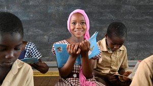Girl attending class holding a book