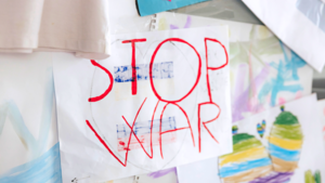 Children's drawing on a wall that reads 'Stop War'