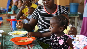 A girl eats in her school.