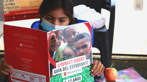 Sammy reads in the Child Friendly Spaces.