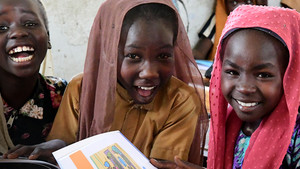 Girls smile in class.