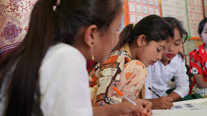 Jannat studies in class in Bangladesh.