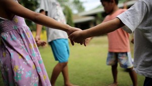Children at playground holding hands