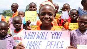 An African girl holding a sign "Who will make peace with"