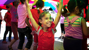 Girl smiling and raising her arms