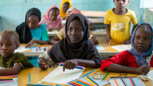 Girls inside a classroom colouring books