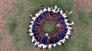 Girls seated in a circle in the DRC.
