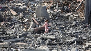 Girl walking through rubble in Gaza