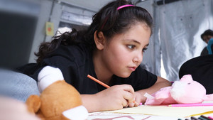 Girl drawing on a piece of paper