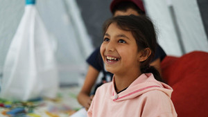 Girl smiling at a refugee camp in Armenia