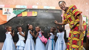 Teacher with schoolgirls in a classroom