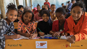 Children inside a classroom smiling in Ethiopia