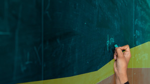 Girl writing on blackboard