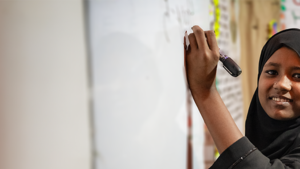 Girl writing on board