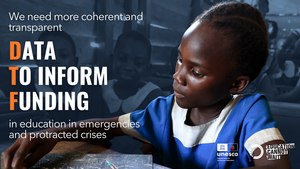 Girl inside classroom sitting down writing on a board