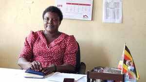 A teacher in Uganda sits in the classroom.