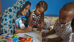 Teacher and children at a learning facility