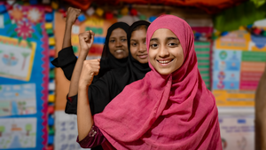 Girls posing for the camera smiling and flexing their arms