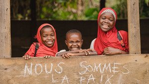 Children inside a classroom smiling