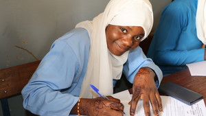 Girl attending class writing in her notebook