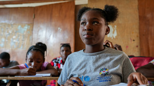 Student sits in class in Haiti.