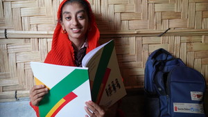 Yasmin in Cox's Bazar reads her book.