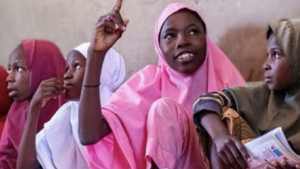 Girl raising her hand during class