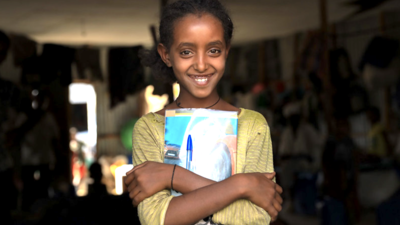 Ethiopian girl smiling and holding books