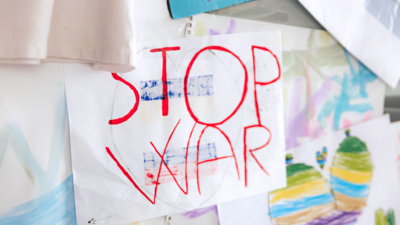 Children's drawing on a wall that reads 'Stop War'