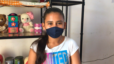 Sinai wears her face mask before heading to school in the morning.