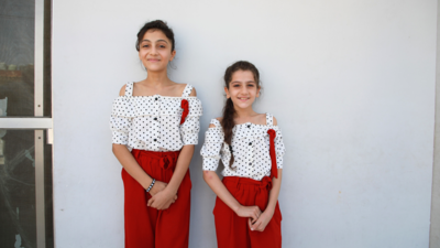 The two Syrian refugee sisters smile as they talk about their dreams.