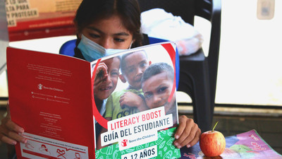 Sammy reads in the Child Friendly Spaces.