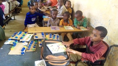 Boy in a wheelchair listens in class.