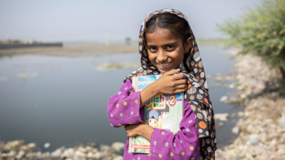 Girl smiling holding a book