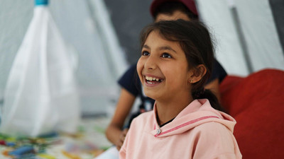 Girl smiling at a refugee camp in Armenia