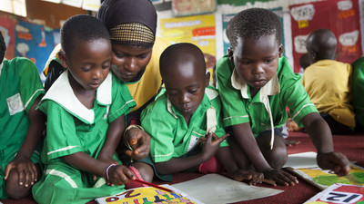 Children working with their teacher in Uganda.
