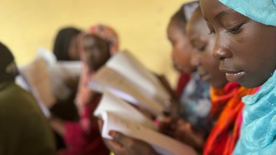 Girls in Sudan reading.