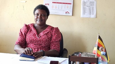 A teacher in Uganda sits in the classroom.