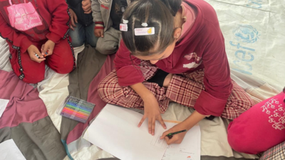 Young girl in Gaza drawing a picture.
