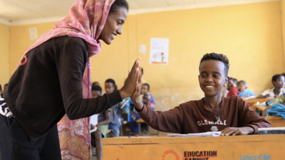 Teacher high-fives her student in Ethiopia.