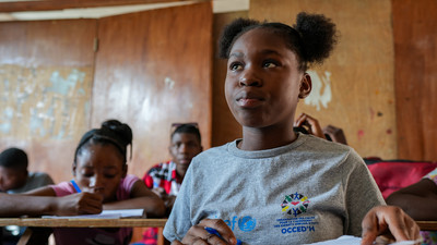 Student sits in class in Haiti.