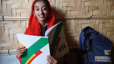 Yasmin in Cox's Bazar reads her book.