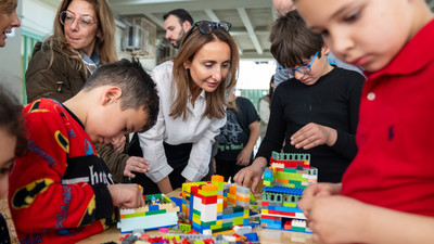 ECW Director Maysa Jalbout interacts with children in a shelter in Lebanon