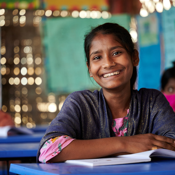 Rohingya refugee girl smiling at class
