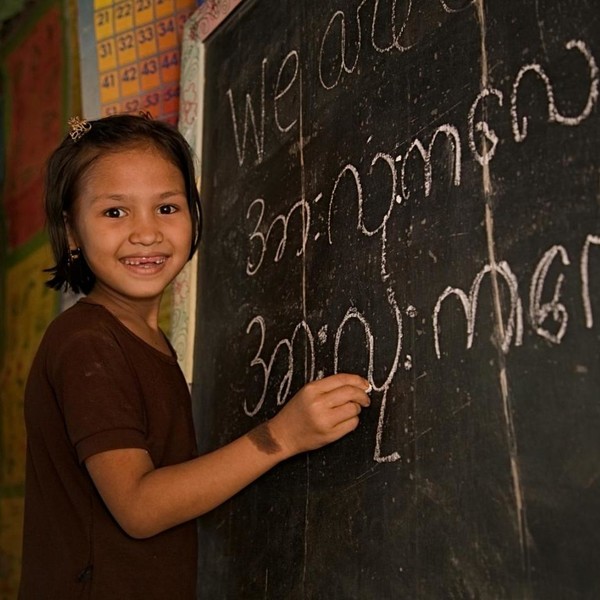 Girl in Bangladesh writes on the board.