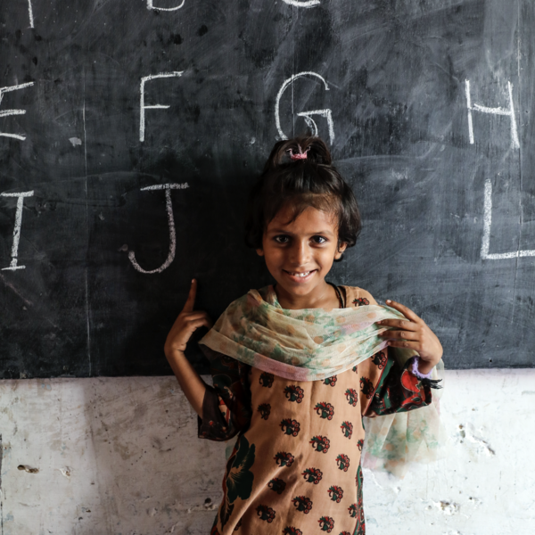 Girl standing in front of blackboard