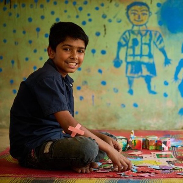 Boy sitting on the floor with art supplies
